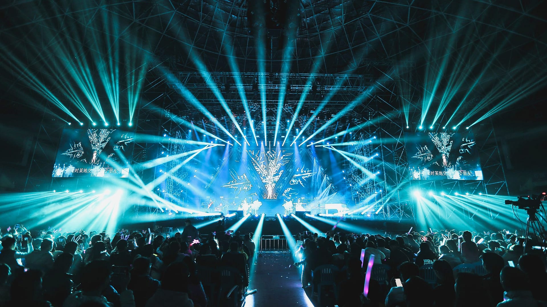A stage painted with hundreds of coloured light beams